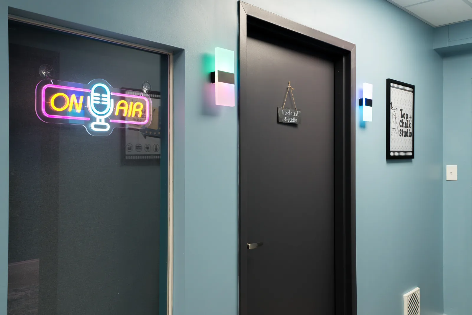 Illuminated ON AIR sign above the sound-treated doors between studio rooms